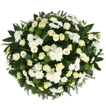 Funeral wreath with white roses, white gerberas, white chrysanthemums, green carnations and decorative foliage.