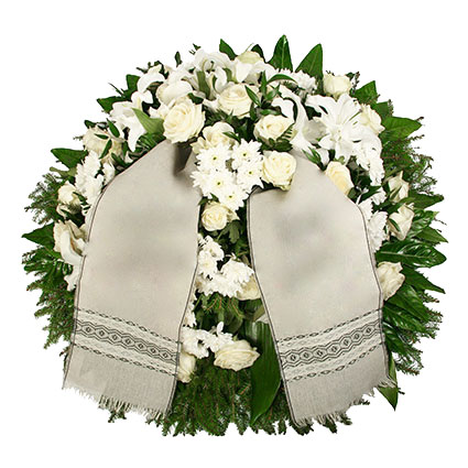 Flowers. Funeral wreath with white roses, white lilies, white chrysanthemums and decorative foliage.
Wreath with a ribbon -