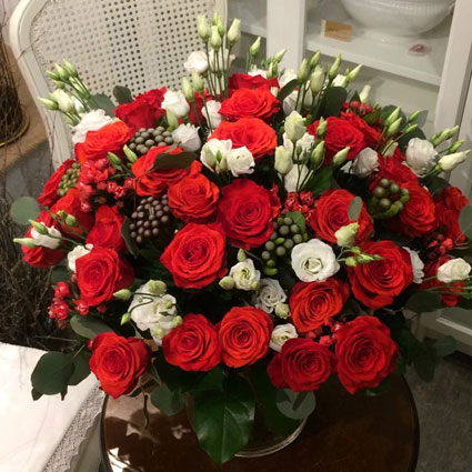Order a premium flower bouquet of red roses, white lisianthus, decorative bouvardia and brunia.