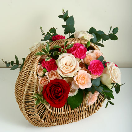 Flower basket of roses, spray roses and spray carnations. Size 31 cm x 30 cm.