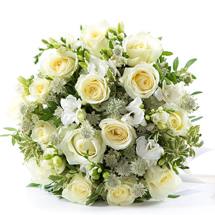 Flowers delivery. White roses, white freesias and decorative fine flowers in an elegant flower bouquet.