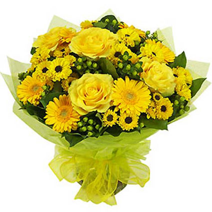 Flower delivery Riga. Sunny bouquet of yellow roses, yellow gerberas and chrysanthemums with decorative berries.