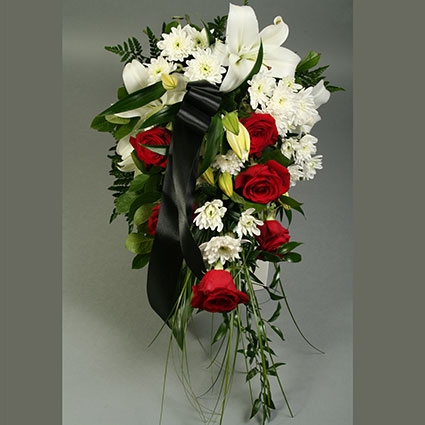 Flower delivery Riga. Funeral bouquet of red roses, white lilies, white chrysanthemums and decorative foliage.