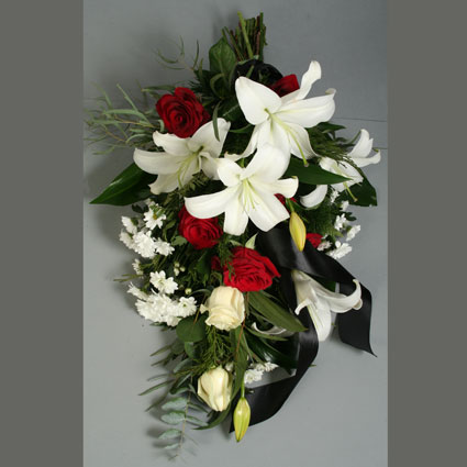 Flower delivery Latvia. Funeral bouquet of red roses, white roses, white lilies, white chrysanthemums and eucalyptus.