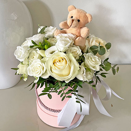 Flower box with white flowers and a Teddy Bear