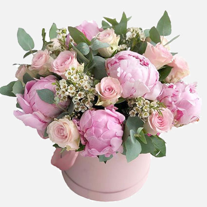 Flower box with peonies and roses in pink tones