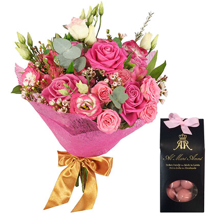 Flowers in Riga. Pink bouquet of roses and lisianthus with decorative foliage andAL MARI ANNI chocolate dragees