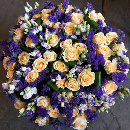 Flowers in Riga. Magnificent bouquet of creamy roses, white and blue lisianthus, blue limonium and decorative foliage.